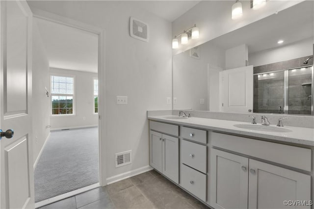 bathroom with vanity, tile patterned flooring, and a shower with shower door