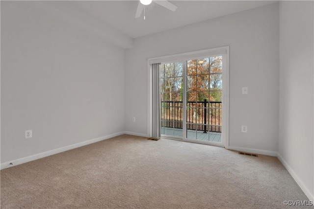 spare room with baseboards, carpet, and ceiling fan