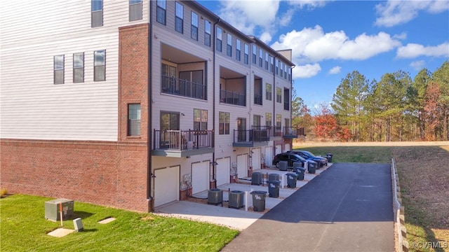 view of property with a garage and central AC unit