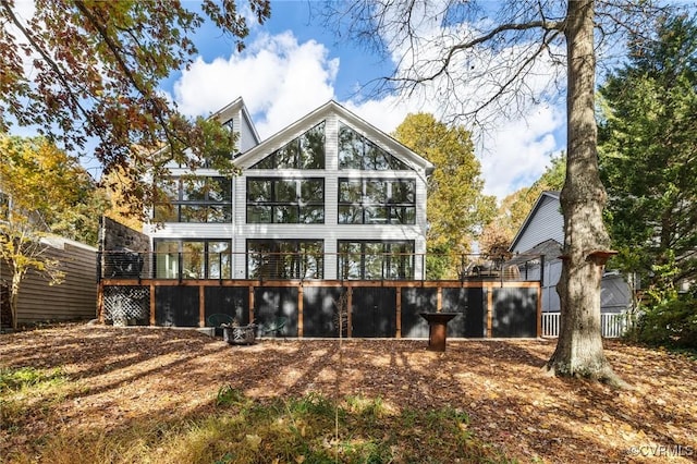 back of property with a sunroom