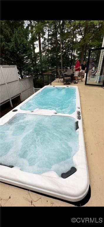 view of pool featuring a jacuzzi