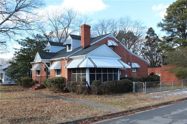 view of home's exterior with a sunroom