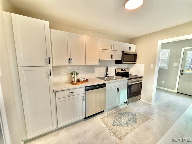 kitchen featuring white cabinetry, sink, and appliances with stainless steel finishes