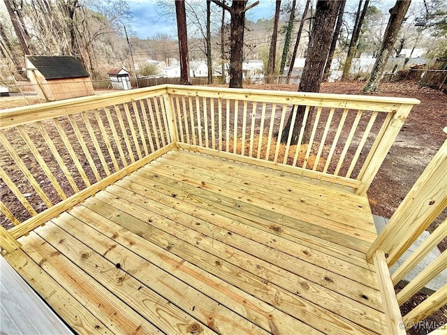 wooden terrace featuring a storage unit