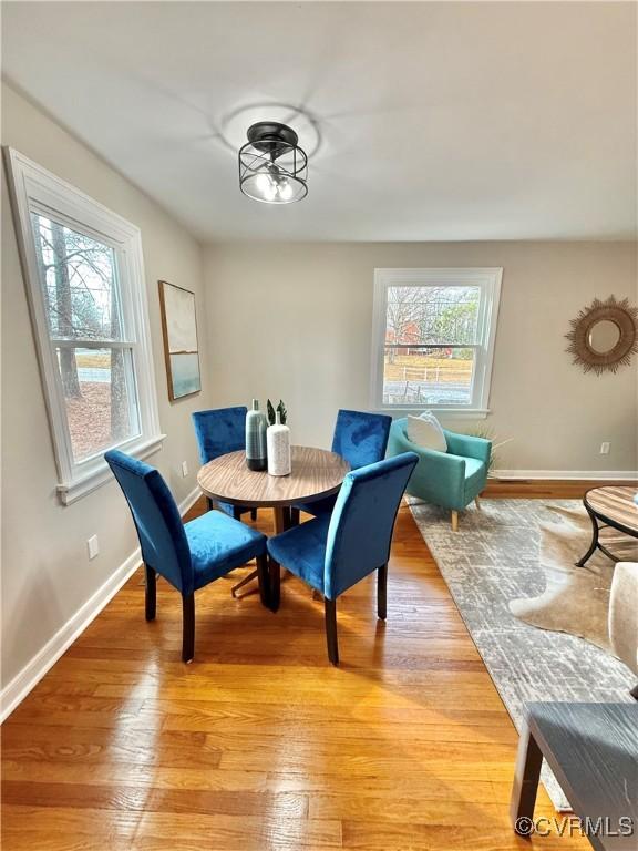 dining area featuring a healthy amount of sunlight and light hardwood / wood-style flooring