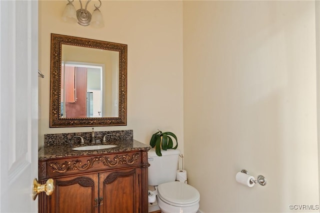 half bath featuring toilet and vanity