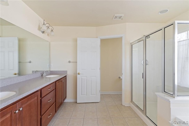 full bath featuring tile patterned flooring, a sink, visible vents, double vanity, and a stall shower