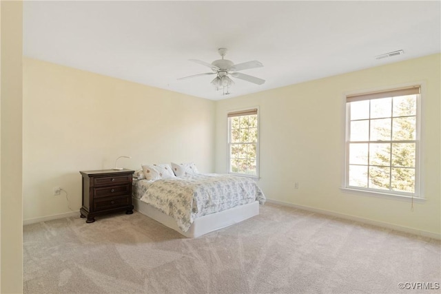 unfurnished bedroom featuring carpet floors, baseboards, visible vents, and a ceiling fan