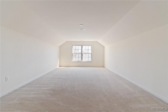 bonus room with lofted ceiling, carpet, and baseboards