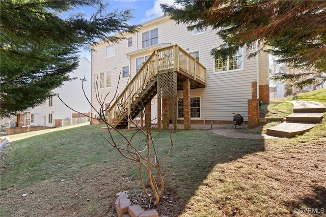 rear view of house featuring a patio area, stairs, a deck, and a lawn