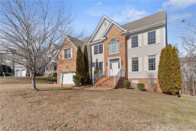 view of front of property featuring a garage and a front lawn