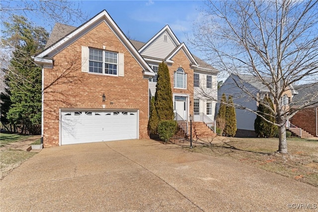 traditional-style house with a garage, concrete driveway, and brick siding