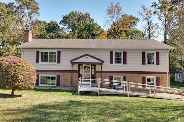 raised ranch with a front yard