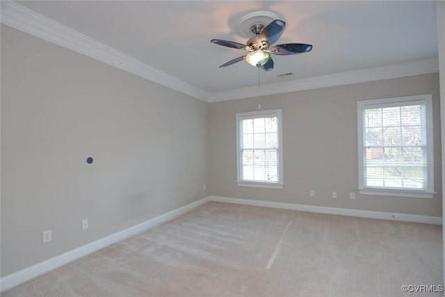 carpeted empty room with ceiling fan and ornamental molding