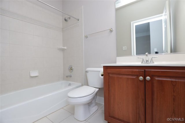 full bathroom with tiled shower / bath, tile patterned floors, toilet, and vanity