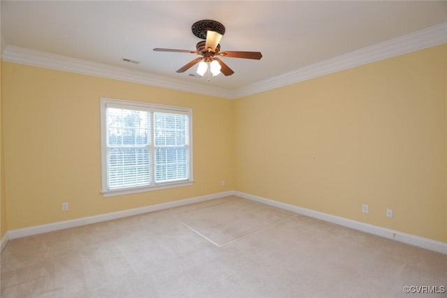 carpeted spare room with ornamental molding and ceiling fan