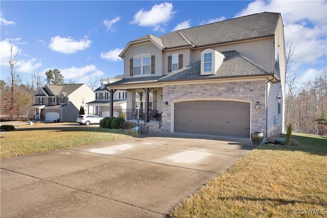 view of front of home featuring a garage, covered porch, and a front yard