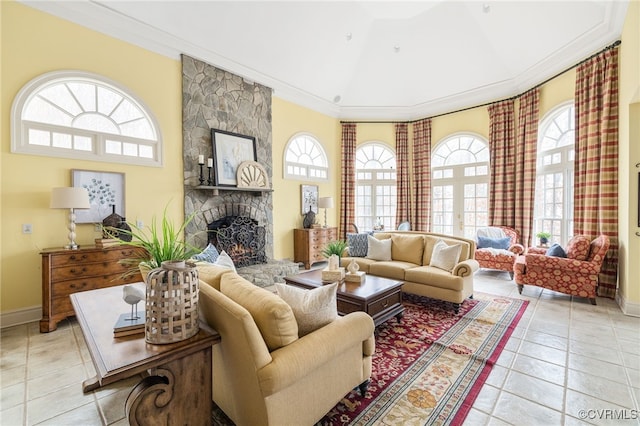 tiled living room featuring lofted ceiling, a fireplace, ornamental molding, and a healthy amount of sunlight