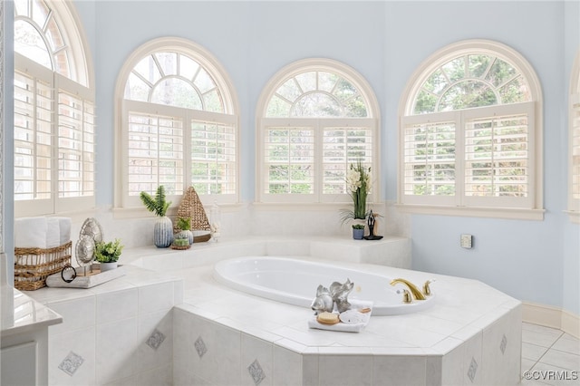 bathroom featuring a relaxing tiled tub