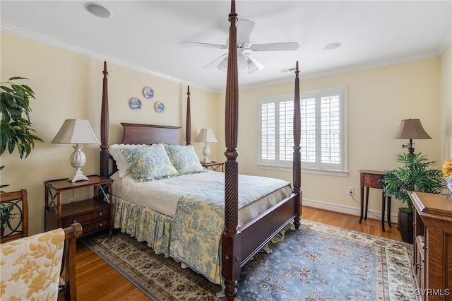 bedroom with crown molding, hardwood / wood-style floors, and ceiling fan