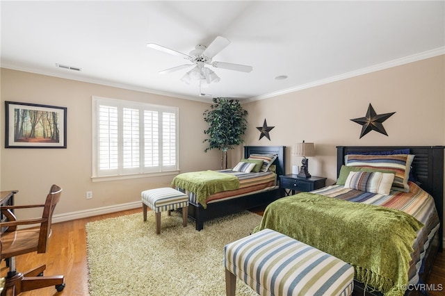 bedroom featuring wood-type flooring, ornamental molding, and ceiling fan