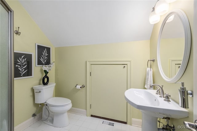 bathroom featuring vaulted ceiling and toilet