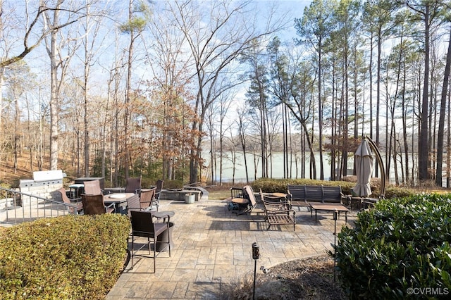 view of patio featuring a water view and an outdoor fire pit