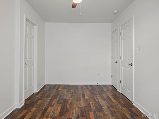 empty room featuring dark hardwood / wood-style floors and ceiling fan