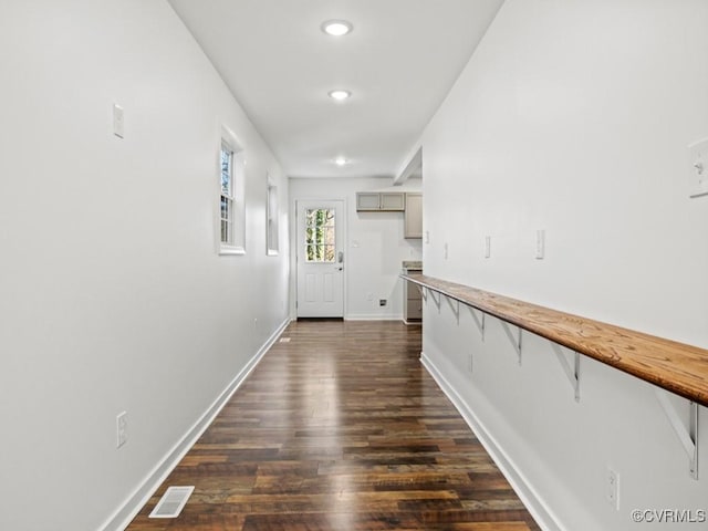 hallway with dark wood-type flooring