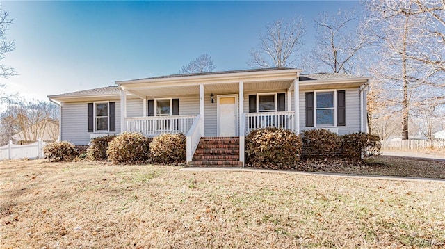 ranch-style house featuring a porch and a front lawn