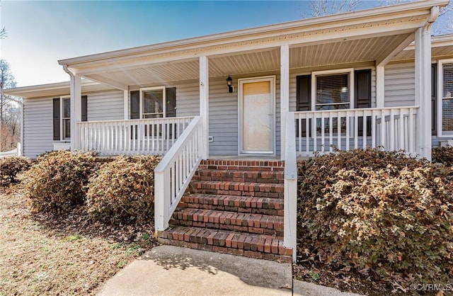 doorway to property featuring covered porch