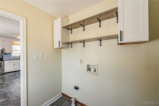 washroom featuring cabinets, washer hookup, and a textured ceiling