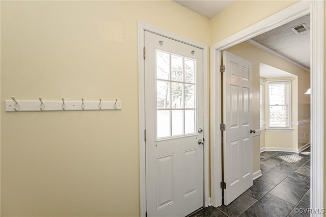 doorway to outside with ornamental molding