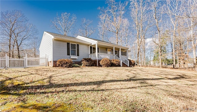 ranch-style house featuring a porch and a front yard