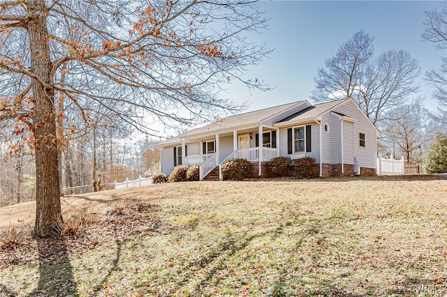 ranch-style home with a porch and a front yard