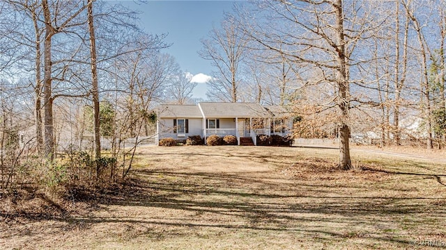 view of front of property with covered porch and a front lawn