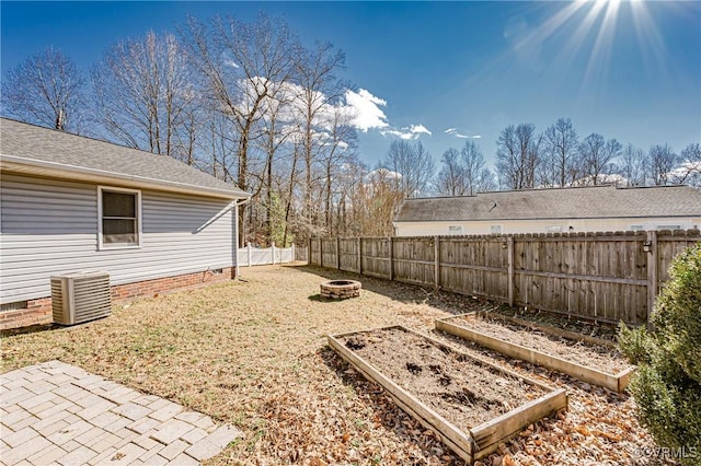 view of yard with cooling unit and an outdoor fire pit