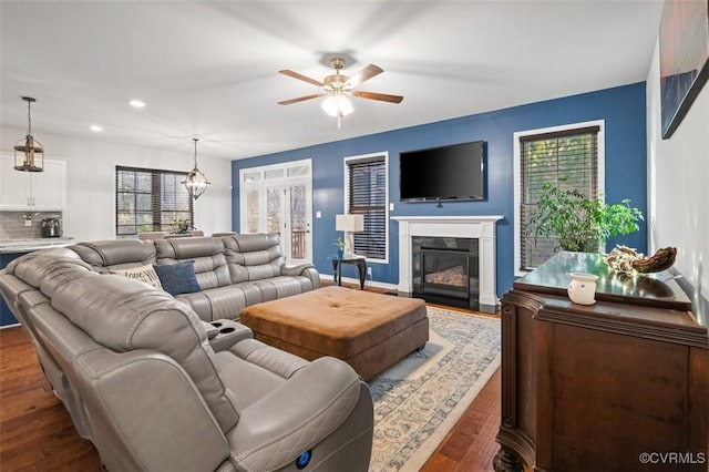 living room with a fireplace with flush hearth, a ceiling fan, wood finished floors, and recessed lighting