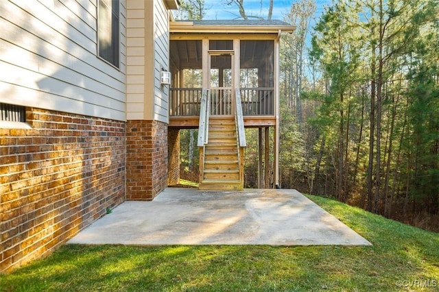 entrance to property featuring brick siding and a patio area