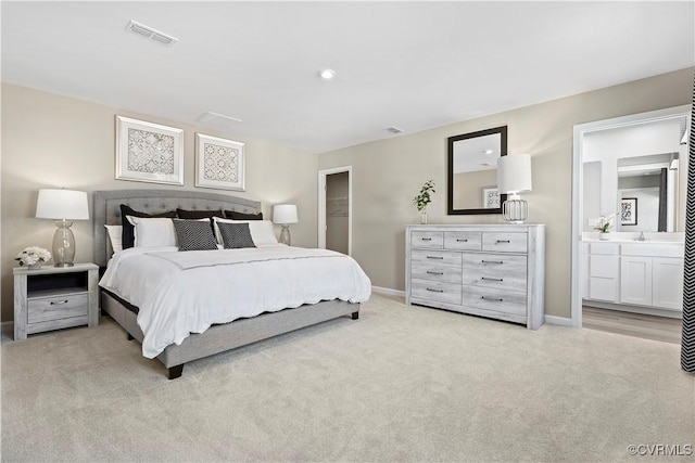 carpeted bedroom featuring connected bathroom