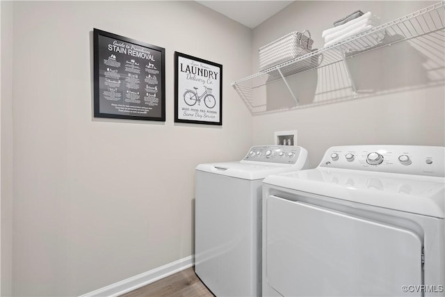 washroom featuring dark hardwood / wood-style floors and washing machine and dryer