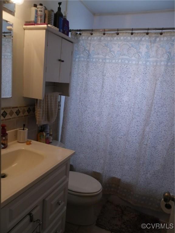 10500 Georgetown Rd, Hanover, VA 23116 - bathroom with vanity, decorative backsplash, toilet, and walk in shower