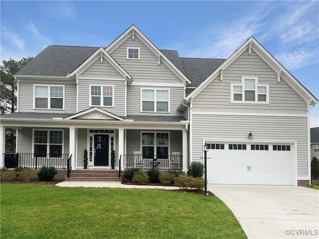 craftsman-style house featuring a garage, a front yard, and covered porch