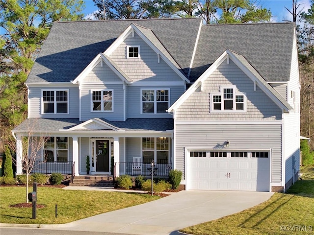 craftsman inspired home with a garage, a front yard, and covered porch