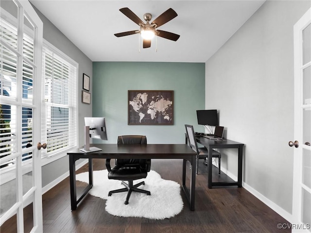 home office with dark wood-type flooring and ceiling fan