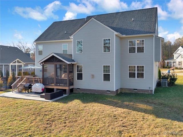 rear view of property with a lawn, a patio, a wooden deck, a sunroom, and central air condition unit