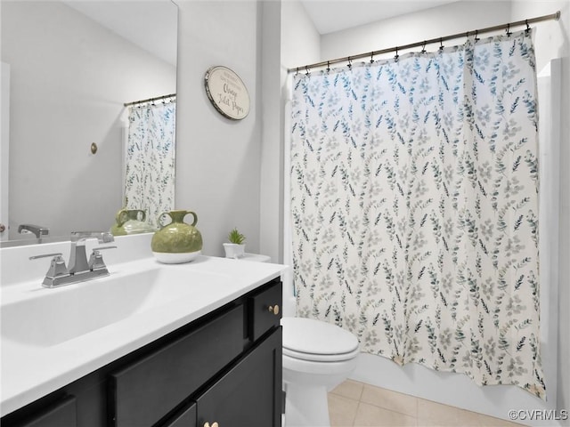 bathroom featuring vanity, tile patterned floors, and toilet