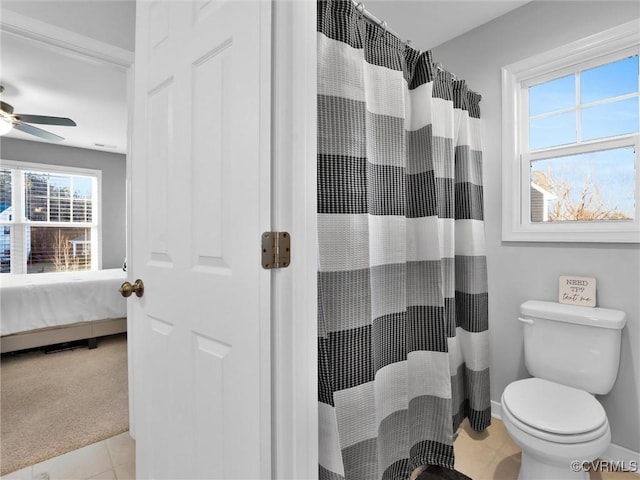 bathroom featuring a shower with curtain, ceiling fan, tile patterned floors, and toilet