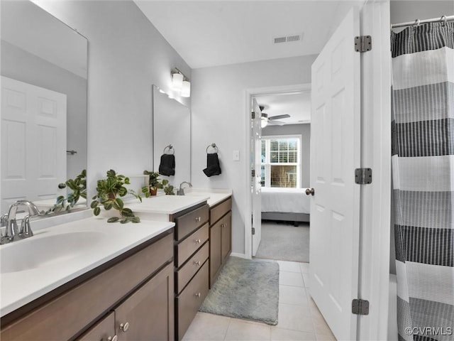 bathroom with vanity, curtained shower, tile patterned floors, and ceiling fan