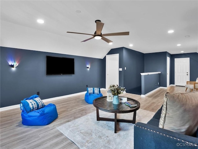 living room with hardwood / wood-style floors, vaulted ceiling, and ceiling fan